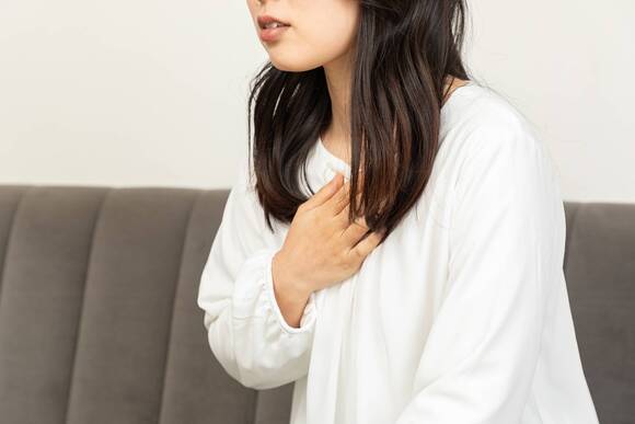 胸をおさえる女性